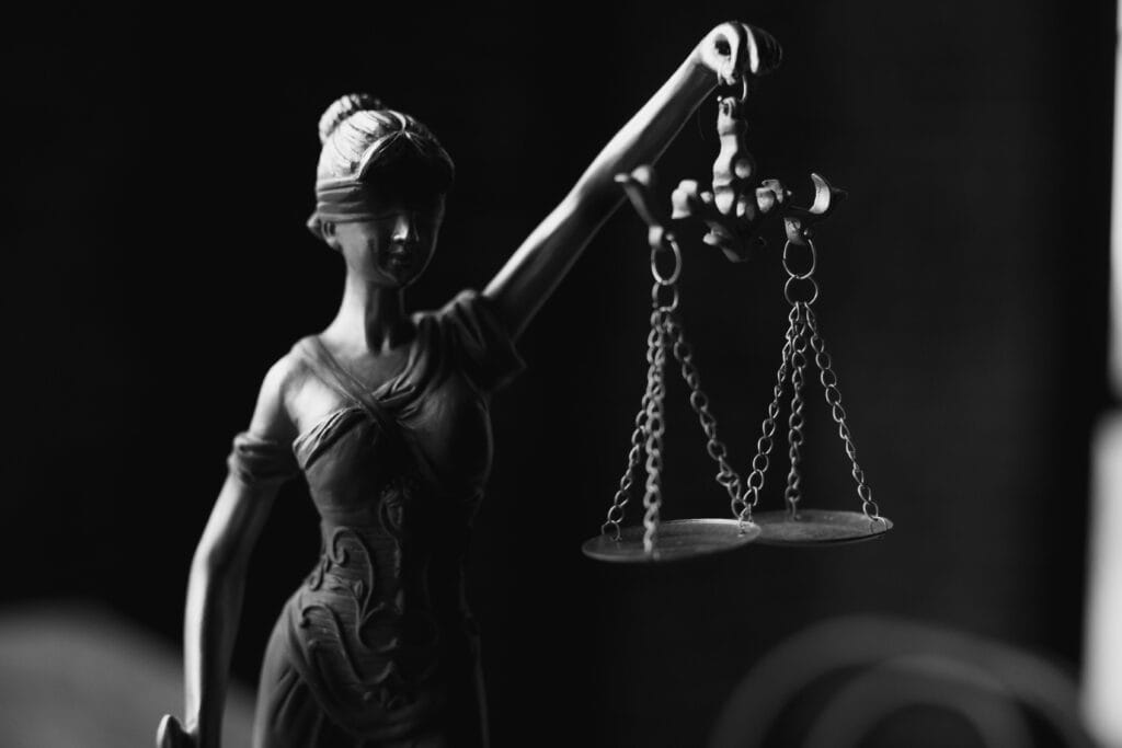 Lady Justice statue holding scales, symbolizing legal fairness in sexual assault lawsuits.