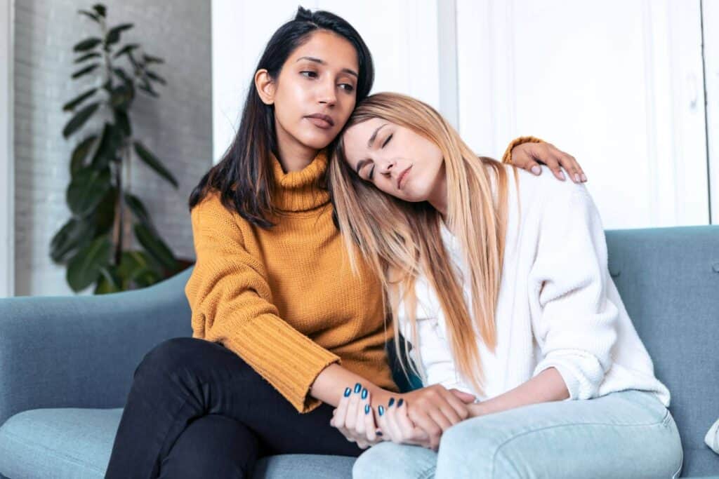 Supportive women comforting each other during a difficult time.